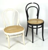 Two vintage Thonet bentwood chairs, one white painted, the other black,