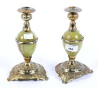A pair of mid century onyx and metal candlesticks,