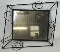 A 20th century wall mirror, of rectangular form, the metal frame of artistic form,