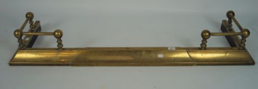 A late 19th/early 20th century brass fender of profiled form,