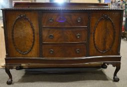 A large serpentine fronted mahogany sideboard with moulded gallery back,
