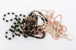 Four contemporary necklaces, all strung with coral,
