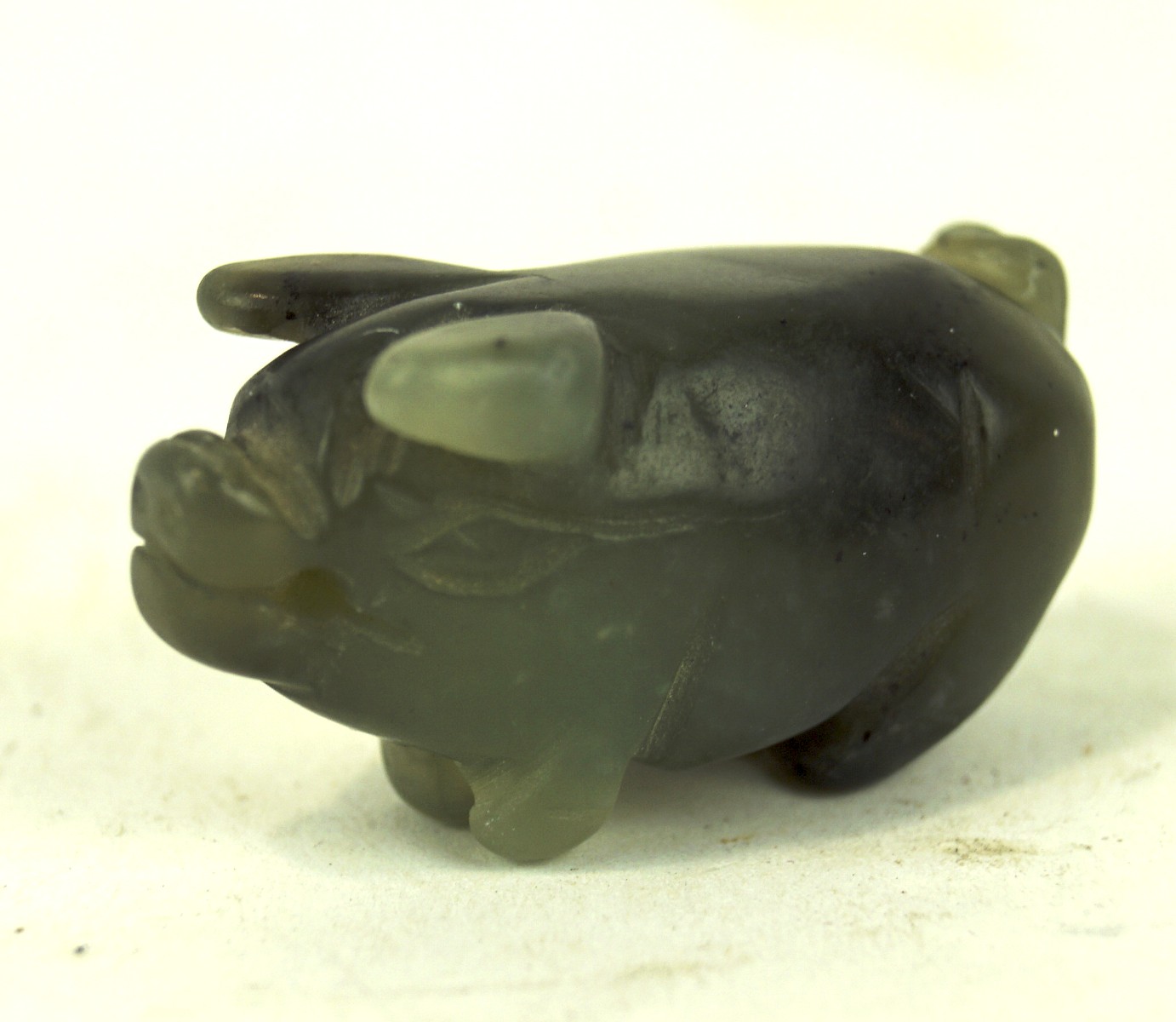 A contemporary carved hardstone figure in the form of a pig, with pierced pendant hole,