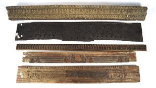 A quantity of wooden mouldings carved with various foliate designs, two with remains of paint,