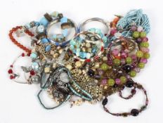 A collection of costume jewellery, including bangles, strings of beads, necklaces,