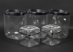 Three large oval plastic ice buckets with chromed rims, with two smaller liners and covers,