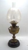 An early 20th century brass oil lamp, British made, with glass shade and funnel,