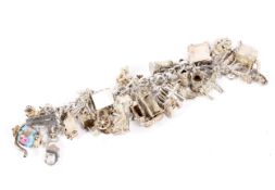 A 20th century silver and white metal charm bracelet,