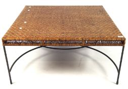 A large wicker topped coffee table, of square form with a metal frame,