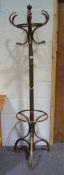 A vintage coat stand with turned support and bentwood hooks and tripod support,