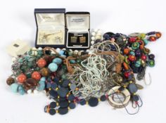 A selection of costume jewellery, including a wooden pendant, beads, a pearl necklace,