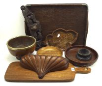 A collection of treen, including a cheeseboard, a twin handled tray, and more