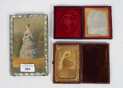 Two 19th century leather bound daguerreotype photos, one depicting Queen Victoria, the other a lady,