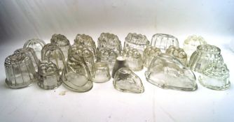 A large selection of glass jelly moulds, of assorted sizes and designs,