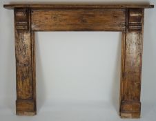 A large stained pine fire surround with mantel shelf on two cabriole supports,