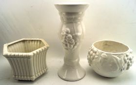 A jardiniere and stand together with a single jardiniere,