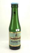 A large 20th century oversized Babycham bottle, adapted into a money bank,