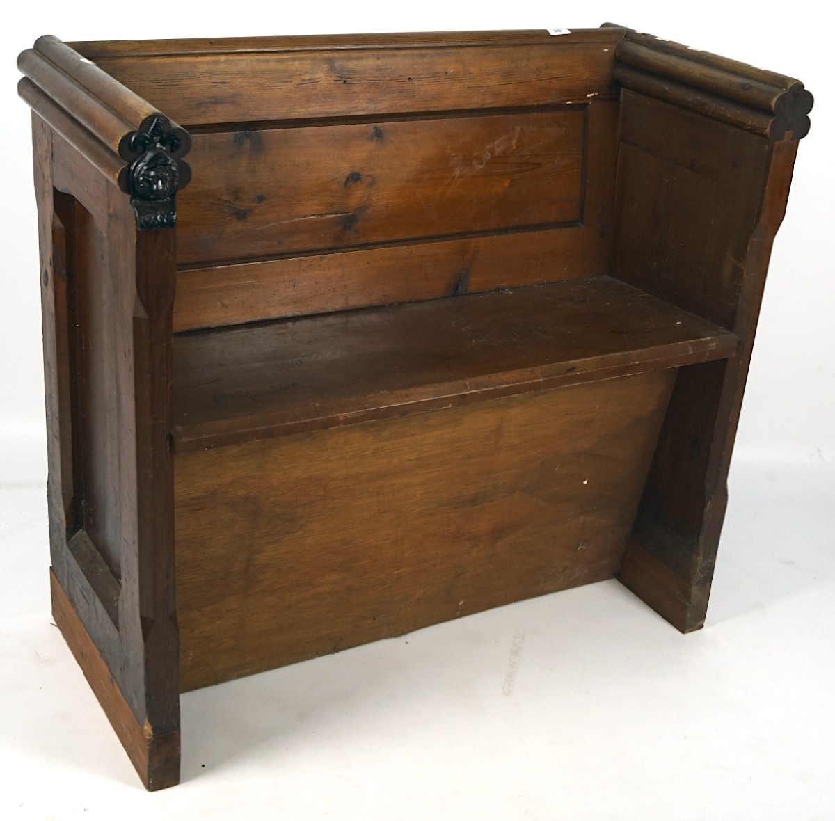 A late 19th/early 20th century stained wooden church pew,