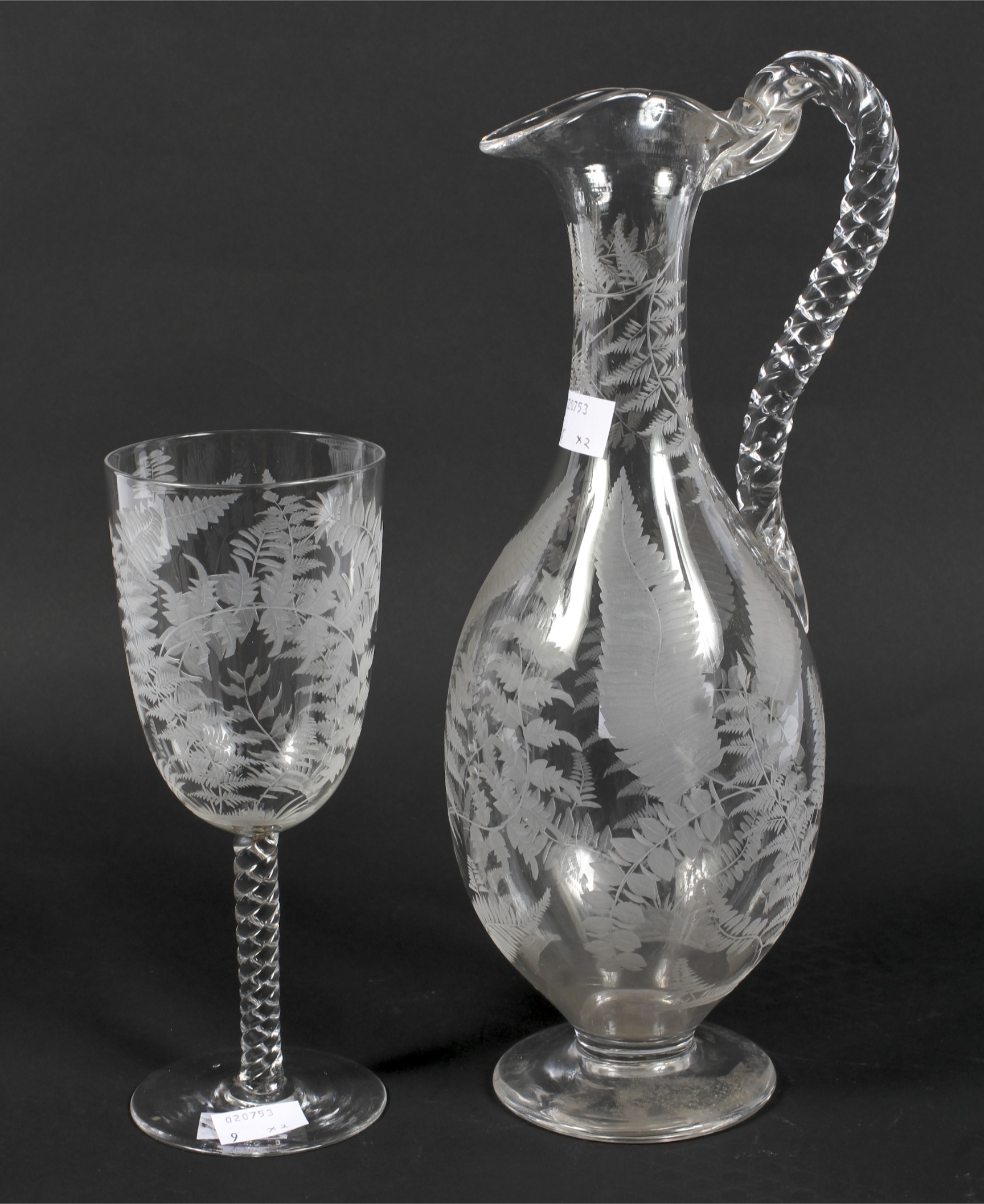 A 19th century engraved glass pouring jug and matching glass.