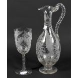 A 19th century engraved glass pouring jug and matching glass.