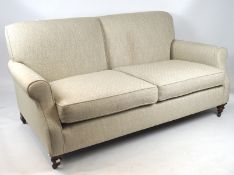 A two seater sofa, with gray and cream patterned upholstery,