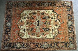 A silk blend Persian style carpet, the rug with a central cream medallion on a red ground,
