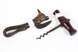 A 19th century cast metal tin opener and wooden handled corkscrew