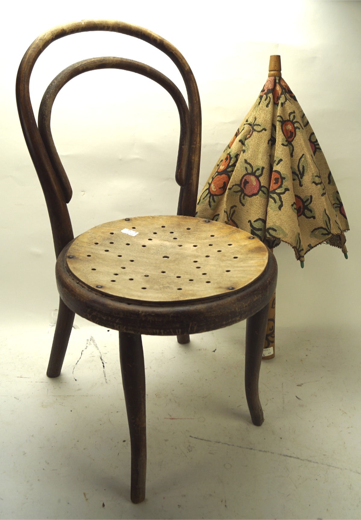 A child's bentwood cafe chair and a parasol,
