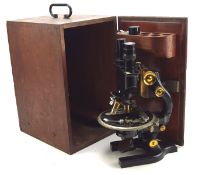 A Spencer 'Buffalo' microscope with lenses,