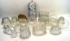 A large collection of assorted glass jelly moulds,