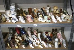 A large collection of ceramic and pottery shoe and boot ornaments,