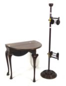 An early 20th century stained mahogany folding occasional table and a wool spinner,