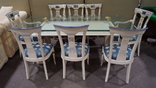A dining table and eight matching chairs,