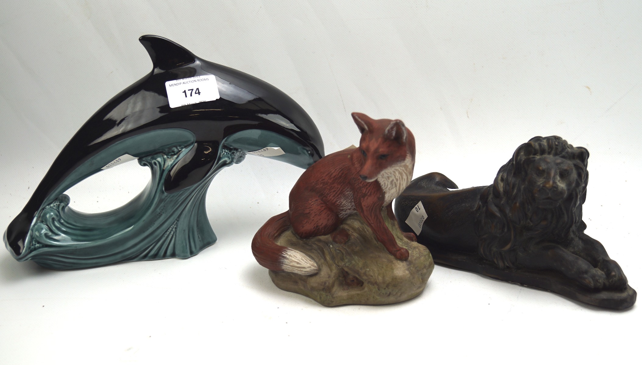 Two Poole pottery animals and a resin sculpture of a lion,