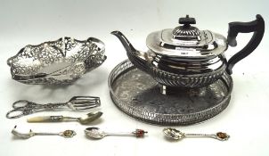 A selection of silver plated wares, including a teapot, pierced circular tray, handled dish,