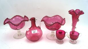 A collection of cranberry glassware,