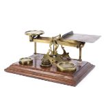A large set of postal scales complete with brass weights on mahogany base