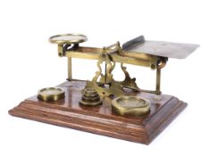 A large set of postal scales complete with brass weights on mahogany base