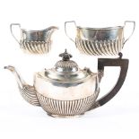 An early 20th century Silver batchelor's teapot and a similar cream jug and sugar bowl set,