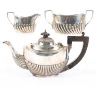 An early 20th century Silver batchelor's teapot and a similar cream jug and sugar bowl set,