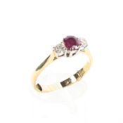 An 18ct gold ruby and two stone diamond dress ring, size N,