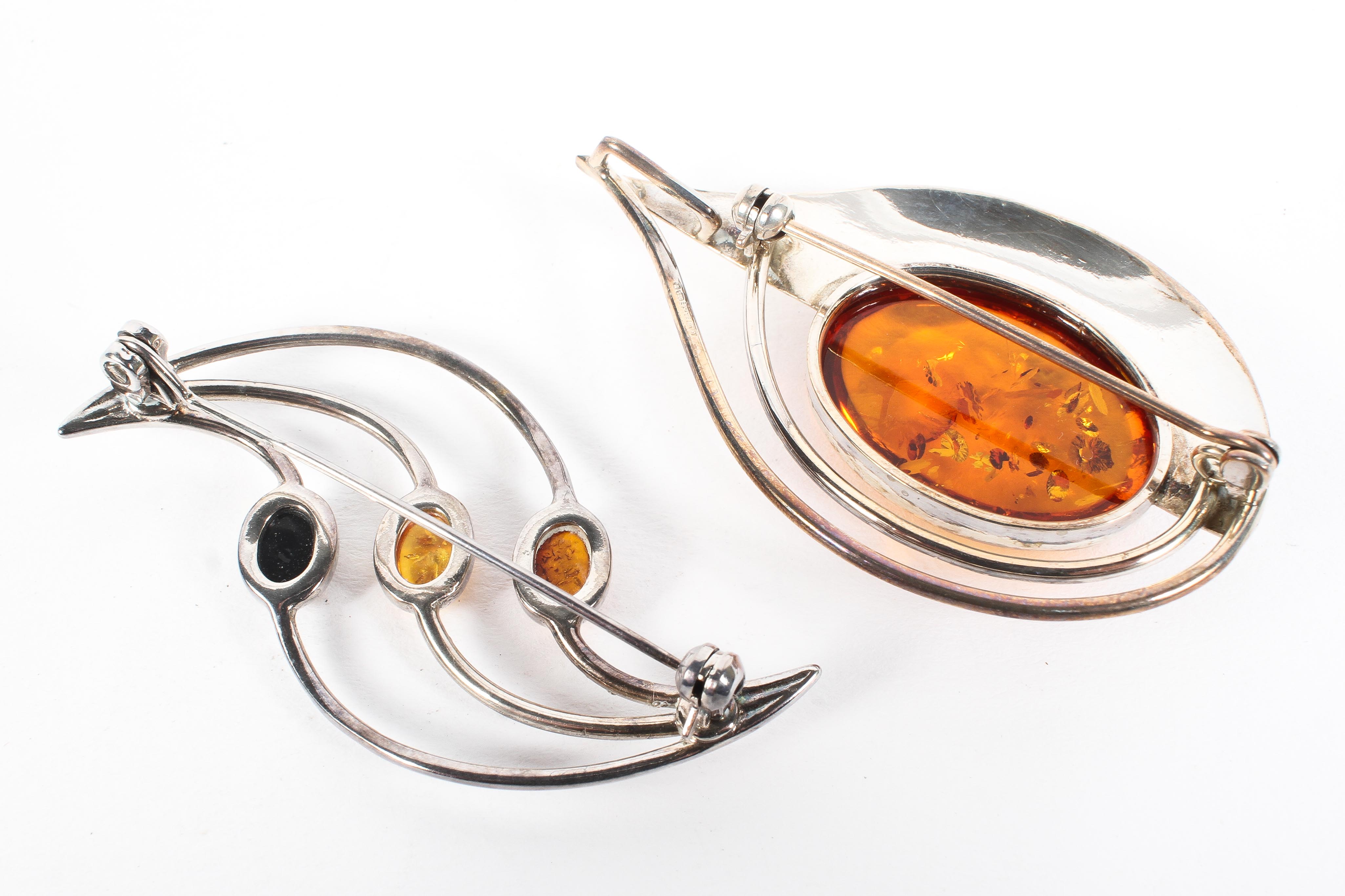 Two contemporary amber brooches set in white metal, each of abstract design, both stamped 925, - Image 2 of 2
