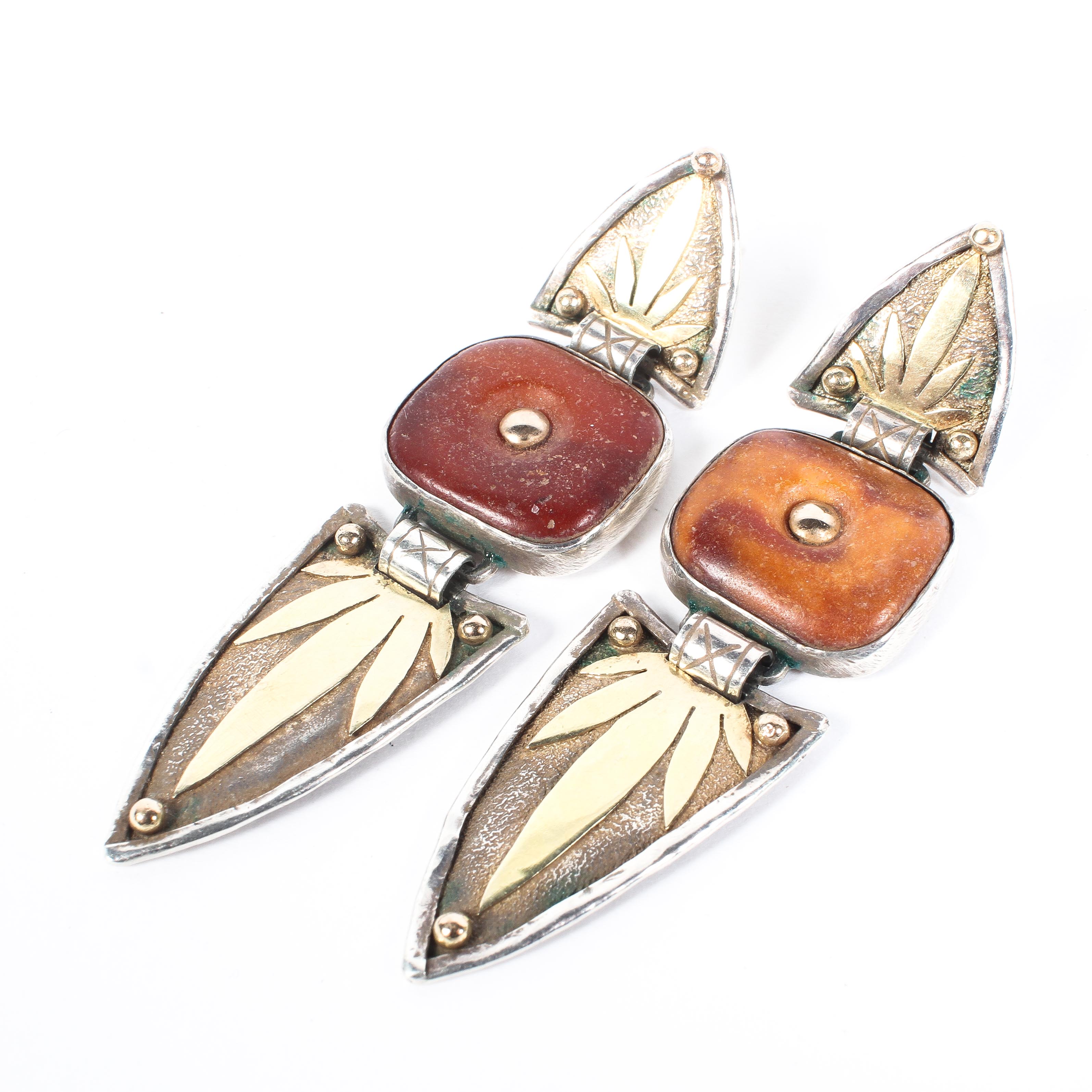 A pair of sterling silver and yellow metal drop earrings with amber coloured settings by CH London.