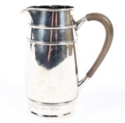 An early 20th century silver cream jug of cylindrical form,