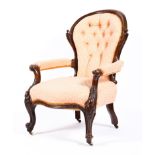 A Victorian mahogany framed button back upholstered armchair, with scroll arms,