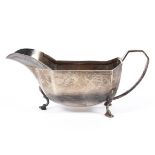 A mid century silver sauce boat, decorated with Art Deco style motifs to border,