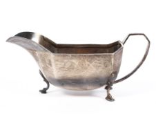 A mid century silver sauce boat, decorated with Art Deco style motifs to border,