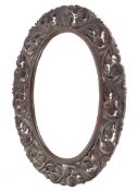 An early oak oval framed wall mirror with pierced decorated frame 85cm height x 65cm wide