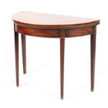 A 19th century mahogany demi loom fold over tea table raised on square tapering supports 97cm