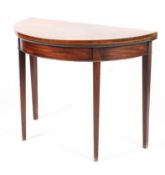 A 19th century mahogany demi loom fold over tea table raised on square tapering supports 97cm